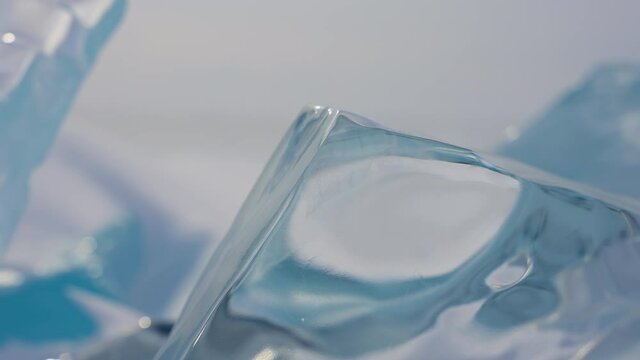 Natural glasslike transparent crystalline ice block. Glacial slab glares.
