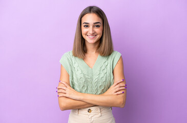 Young caucasian woman isolated on purple background keeping the arms crossed in frontal position