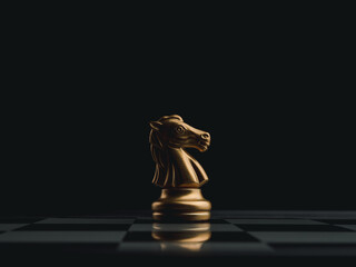 The golden horse, knight chess piece standing alone on chessboard on dark background. Leadership,...