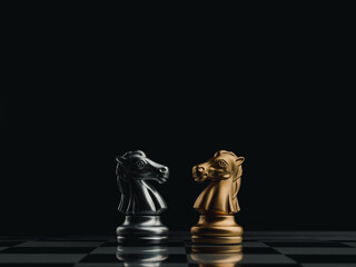 The confront between golden and silver horses, knight chess piece standing together on chessboard...