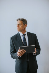 Business man using digital tablet by the wall in the office