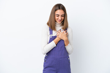 Young caucasian woman isolated on white background having a pain in the heart