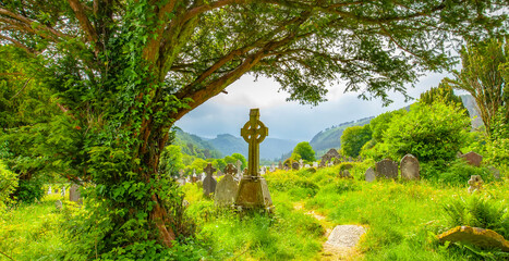 Celtic cross in old Irish graveyard in Glendalough, Ireland
