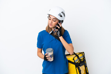 Young caucasian woman with thermal backpack isolated on white background holding coffee to take away and a mobile