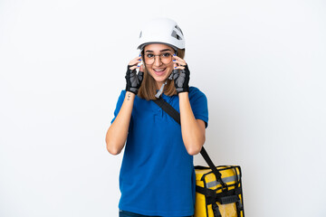 Young caucasian woman with thermal backpack isolated on white background with glasses and surprised