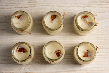 Set for crafting candle on wooden background. Eco soy wax on white table. DIY candle. Hobby concept.