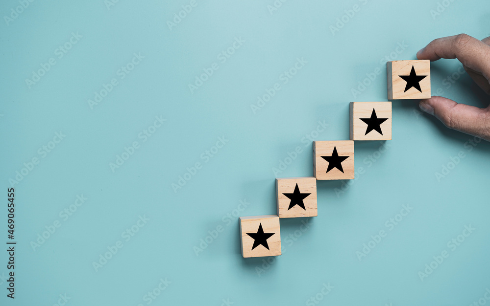 Poster hand stacking for five stars increasing on blue background for client customer evaluation after use 