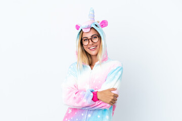 Blonde Uruguayan girl wearing a unicorn pajama isolated on white background with glasses and smiling © luismolinero