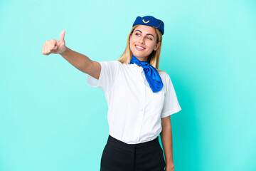 Airplane stewardess Uruguayan woman isolated on blue background giving a thumbs up gesture