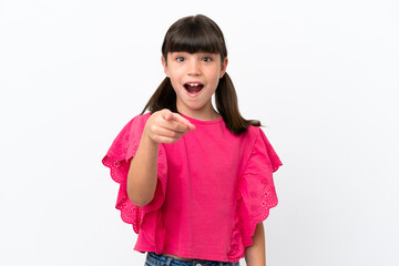 Little caucasian kid isolated on white background surprised and pointing front