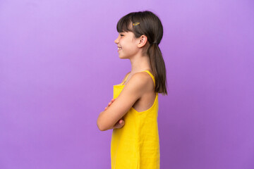 Little caucasian kid isolated on purple background in lateral position