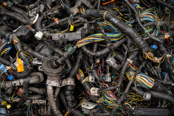 Abandoned electric cables left in the trash basket. Electronic waste problem and recycle.