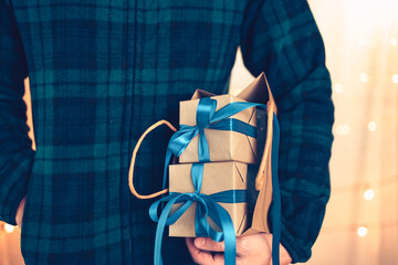 Hands holding gift box, present on the table and light of bokeh background. Valentine's Day, Christmas, Birth day, New year and Anniversary concept.