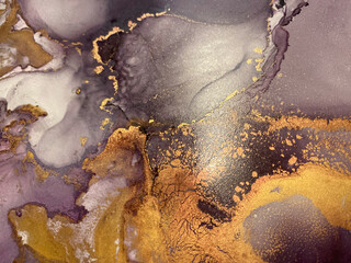 Abstract pink background with gold. Pink fluid art texture made with alcohol ink and golden paint. Beautiful smudges and stains. Backdrop resembles pink marble, petals, watercolor or aquarelle.