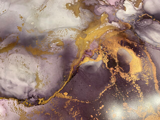 Abstract pink background with gold. Pink fluid art texture made with alcohol ink and golden paint. Beautiful smudges and stains. Backdrop resembles pink marble, petals, watercolor or aquarelle.