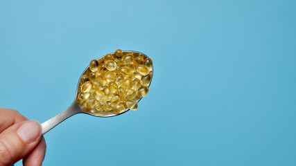 a spoon with many capsules. Vitamins and minerals in a spoon