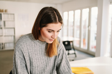 portrait of a woman looking on a desk