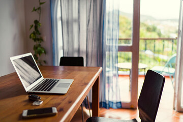 Comfort workplace. Laptop computer on wooden table.