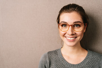 Headshot of happy motivated vivacious young woman with glasses