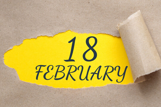 february 18. 18th day of the month, calendar date.Hole in paper with edges torn off. Yellow background is visible through ragged hole.Winter month, day of the year concept