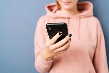 Close up cropped view of a female hand holding a mobile