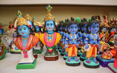 A Collection of clay model dolls of Hindu God Krishna in vibrant colors in India.
