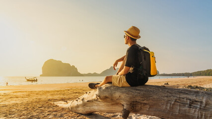 Panorama young man traveler relaxing on summer vacation joy sunset Pak Meng beach, Leisure outdoor...