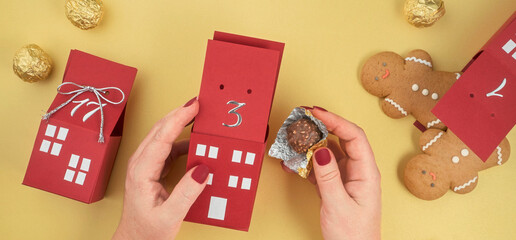 homemade advent calendar made of cardboard boxes with gingerbread men and chocolates, Christmas...