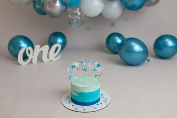 First Birthday blue cake with white grey balloons and stars 