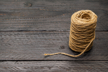 a skein of rope on a dark wooden table