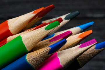 colored pencils on a dark background. close-up