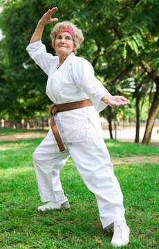 Old Lady Exercising Karate In Park