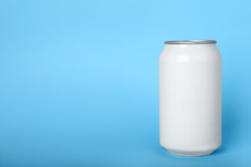 Can of energy drink on light blue background, space for text