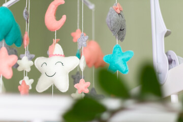 Textile soft toys rotate over the baby's crib. mobile for the cradle.