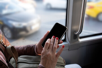 Passenger touching mobile phone screen in transportation vehicle