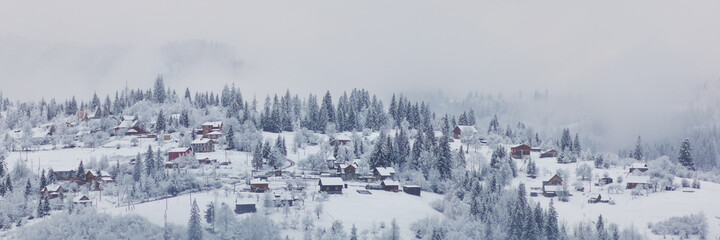 Winter mountain village landscape with snow and cute little houses, beautiful nature panoramic image