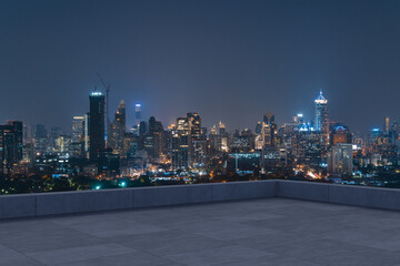 Panoramic Bangkok skyline view, concrete observatory deck on rooftop, night time. Asian corporate...