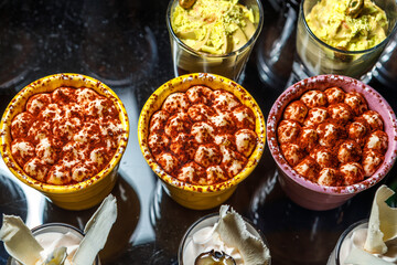 Dessert of whipped cream sprinkled with seasoning in cups.