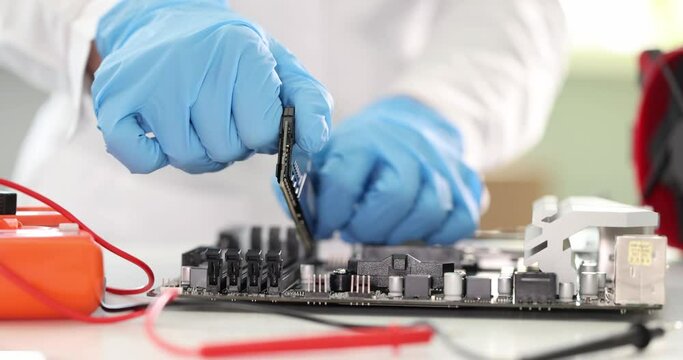 Master inserting ram into computer motherboard closeup 4k movie slow motion