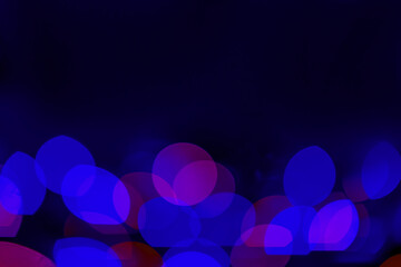 Defocused blue lights over dark background. Natural bokeh and bright blue lights. Magic background with bokeh. Space for text.