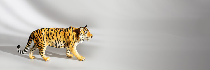 Tiger symbol of the Chinese new year 2022. Figurine of tiger isolated on white background with shadows. Copy space.