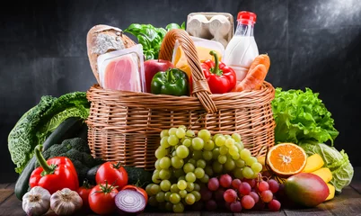 Foto op Plexiglas Wicker basket with assorted grocery products © monticellllo