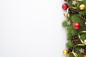 Top view photo of christmas tree decorations gold and red balls pine cones shiny stars and serpentine on pine twigs on isolated white background with copyspace