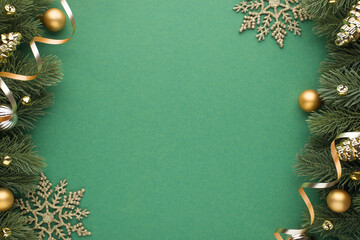 Top view photo of gold and silver christmas tree balls toys cones small bells snowflakes and serpentine on pine branches on isolated green background with empty space - obrazy, fototapety, plakaty