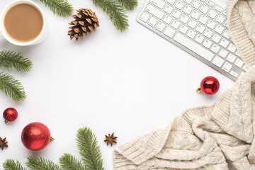 Top view photo of keyboard cup of hot drinking red christmas tree balls pine twigs cone anise and scarf on isolated white background with empty space in the middle