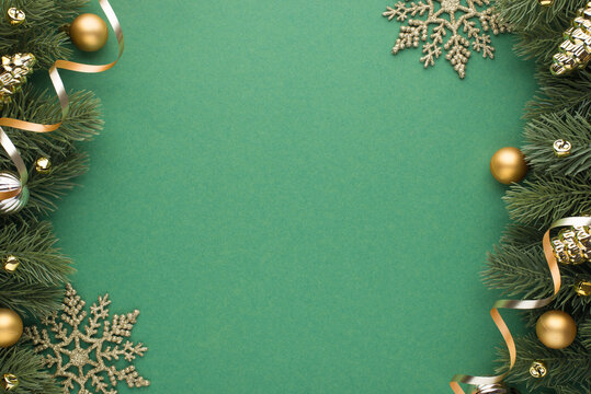 Top view photo of gold and silver christmas tree balls toys cones small bells snowflakes and serpentine on pine branches on isolated green background with empty space