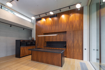 Interior of modern wooden kitchen with built-in appliances in house.