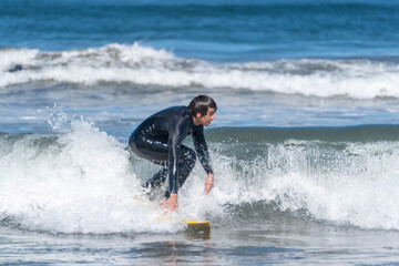 surfing the wave in the beach of La Serena, Chile