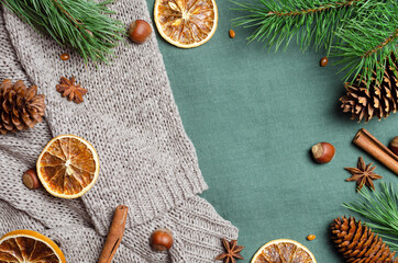 Christmas flat lay with spices and pine tree branches with cones on knitted background