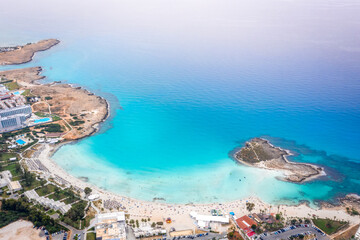 Naklejka premium Aerial view of the most famous beaches in Cyprus - Nissi Beach. White sand beach with azure waters. Beautiful beach and panoramic views of the Cyprus coastline